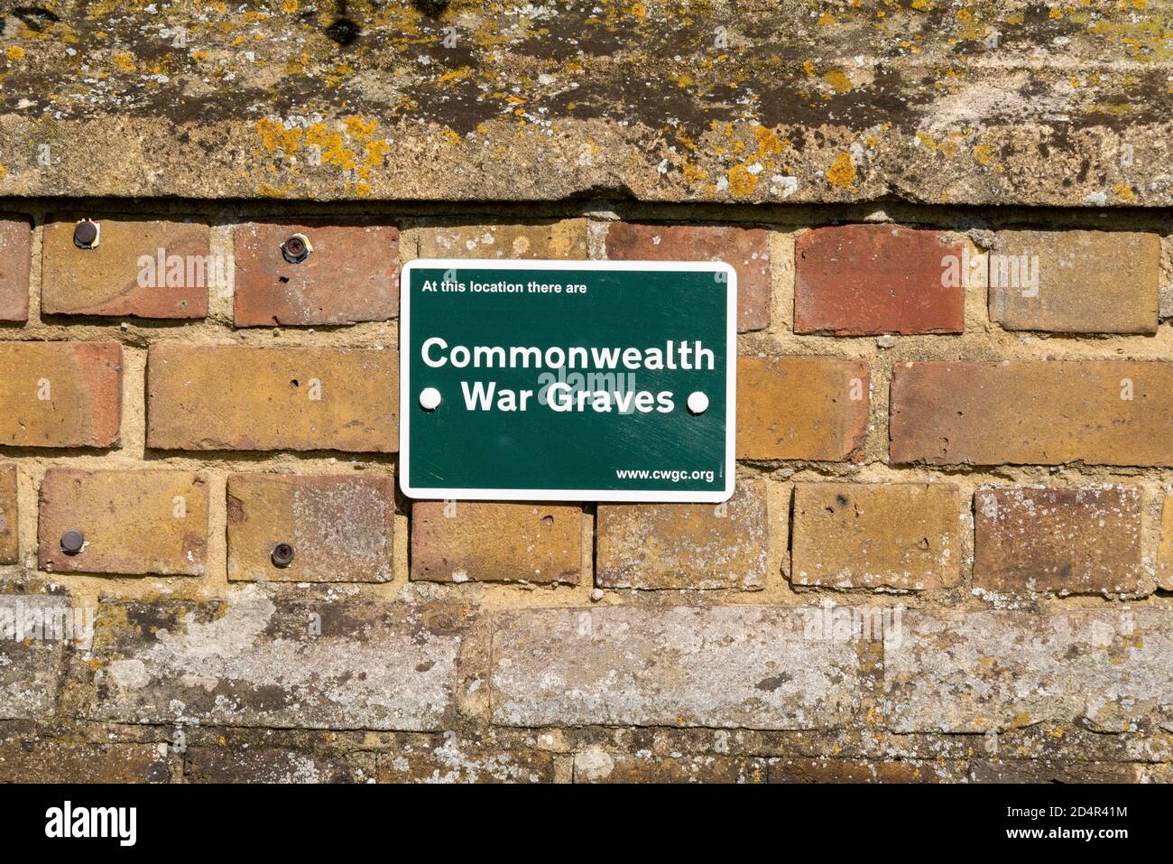 Commonwealth War Graves green sign outside St Laurence and All Saints Church in Eastwood, Southend on Sea, Essex, UK. Stock Photo