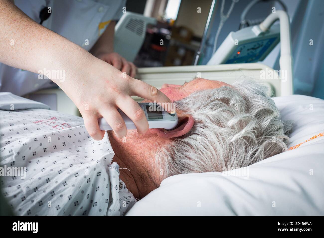 Nurse taking temperature of a patient, France. Stock Photo
