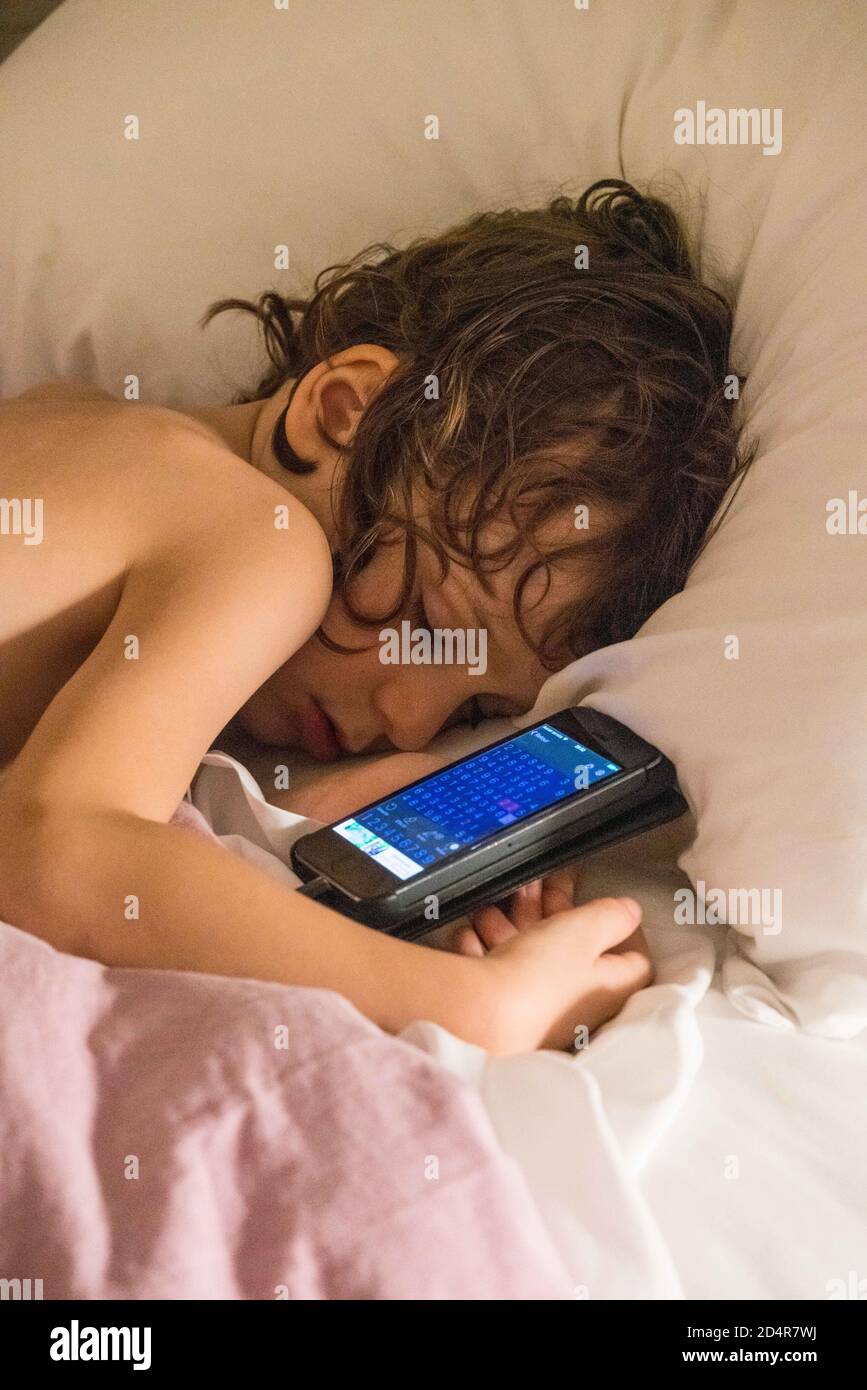 5 year old boy playing with a smartphone. Stock Photo