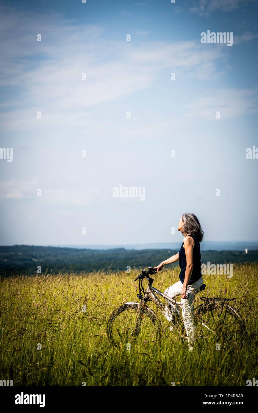 Woman riding bicycle. Stock Photo