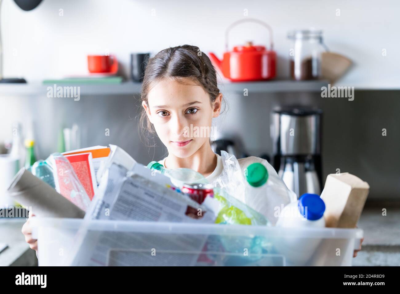 12-year-old girl sorting recycled wastes. Stock Photo