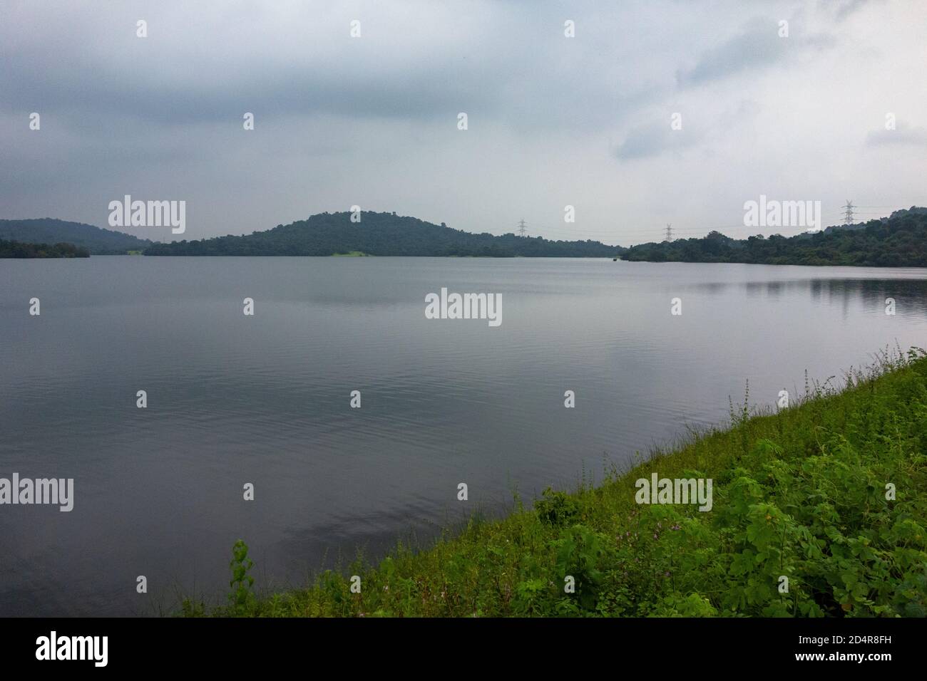 Pleasant view of Amthane Dam reservoir on an overcast day during monsoon season in Goa, India Stock Photo