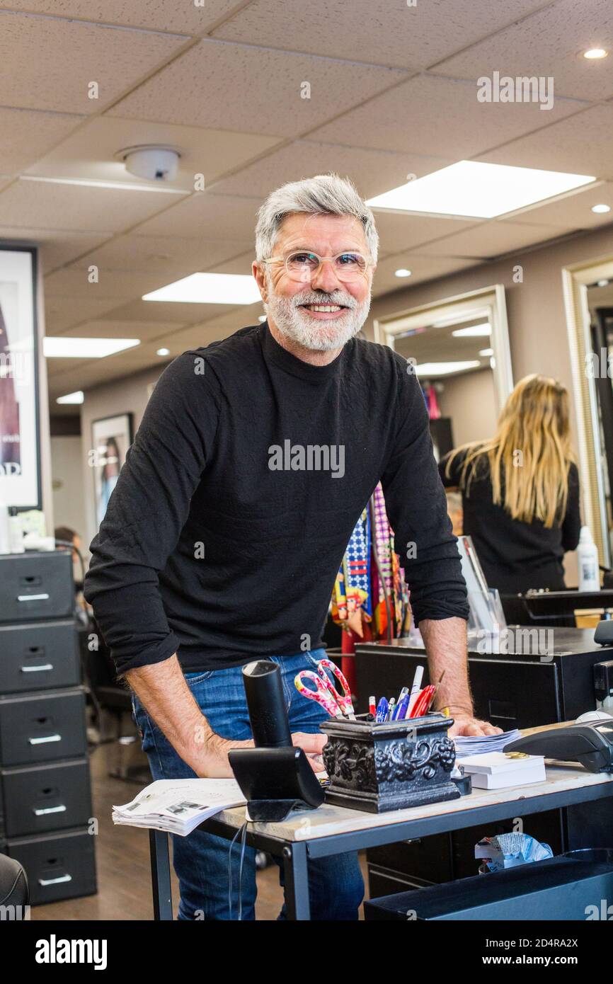 Man working in a hair salon. Stock Photo