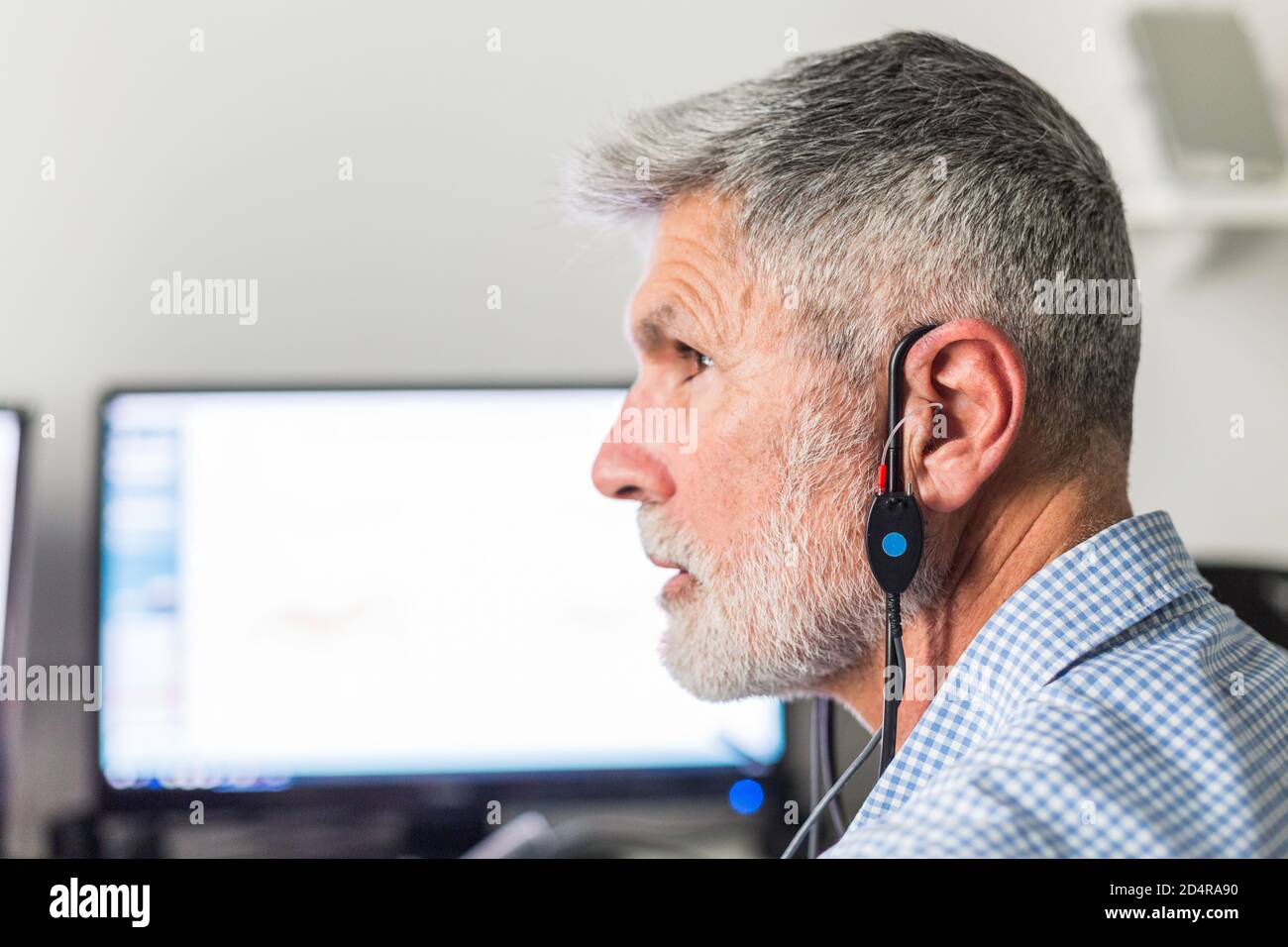 Man undergoing pure-tone audiometry test and hearing threshold measurement. Stock Photo