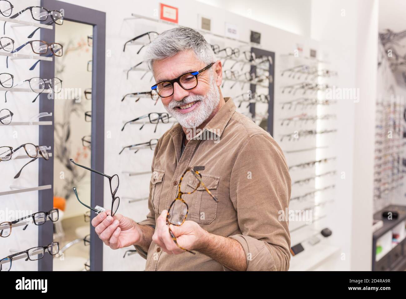 Man trying prescription glasses Stock Photo - Alamy