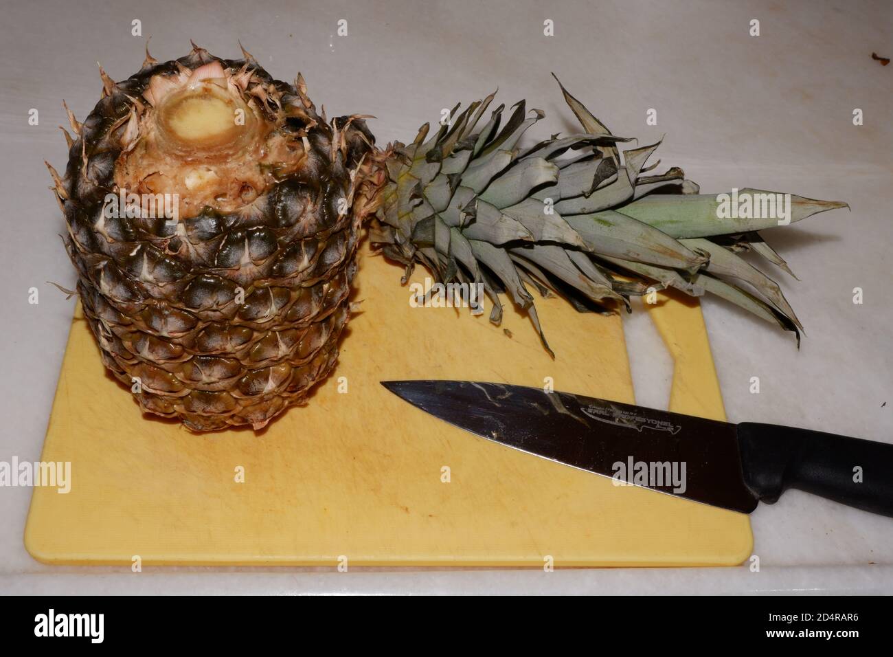 Cut Pineapple and Chef Knife Stock Photo