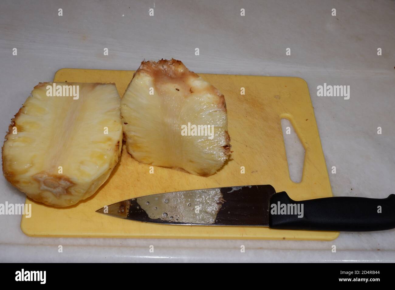 Cut Pineapple and Chef Knife Stock Photo