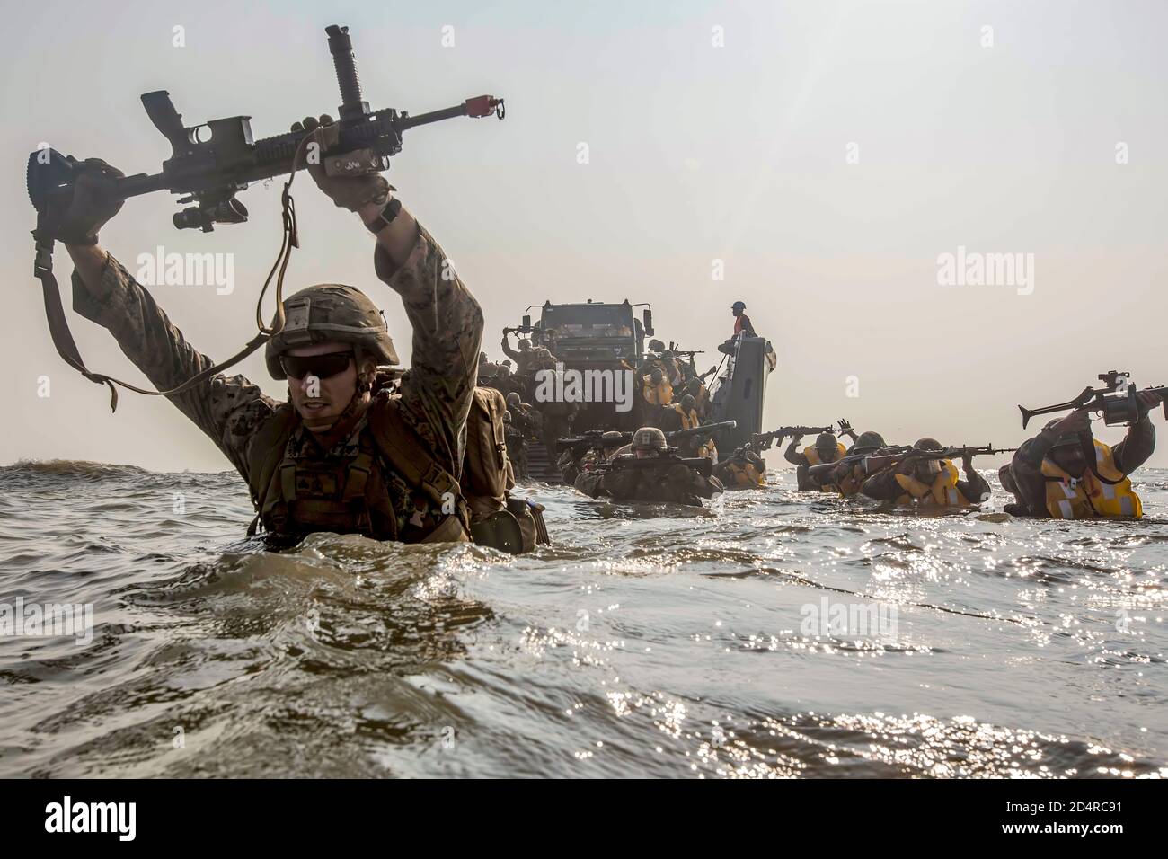 191119-M-ZF985-0070KAKINADA BEACH, India (Nov. 19, 2019) U.S. Marines currently under 4th Marine Regiment, 3rd Marine Division, and members of the Indian military wade to shore during exercise Tiger TRIUMPH on Kakinada Beach, India, Nov. 19, 2019. During Tiger TRIUMPH, U.S. and Indian forces conducted valuable training in humanitarian assistance disaster relief operations by inserting a joint and combined Indian and U.S. force from ship-to-shore in response to a hypothetical natural disaster. While on shore, the forces conducted limited patrolling, moved simulated victims to medical care and p Stock Photo