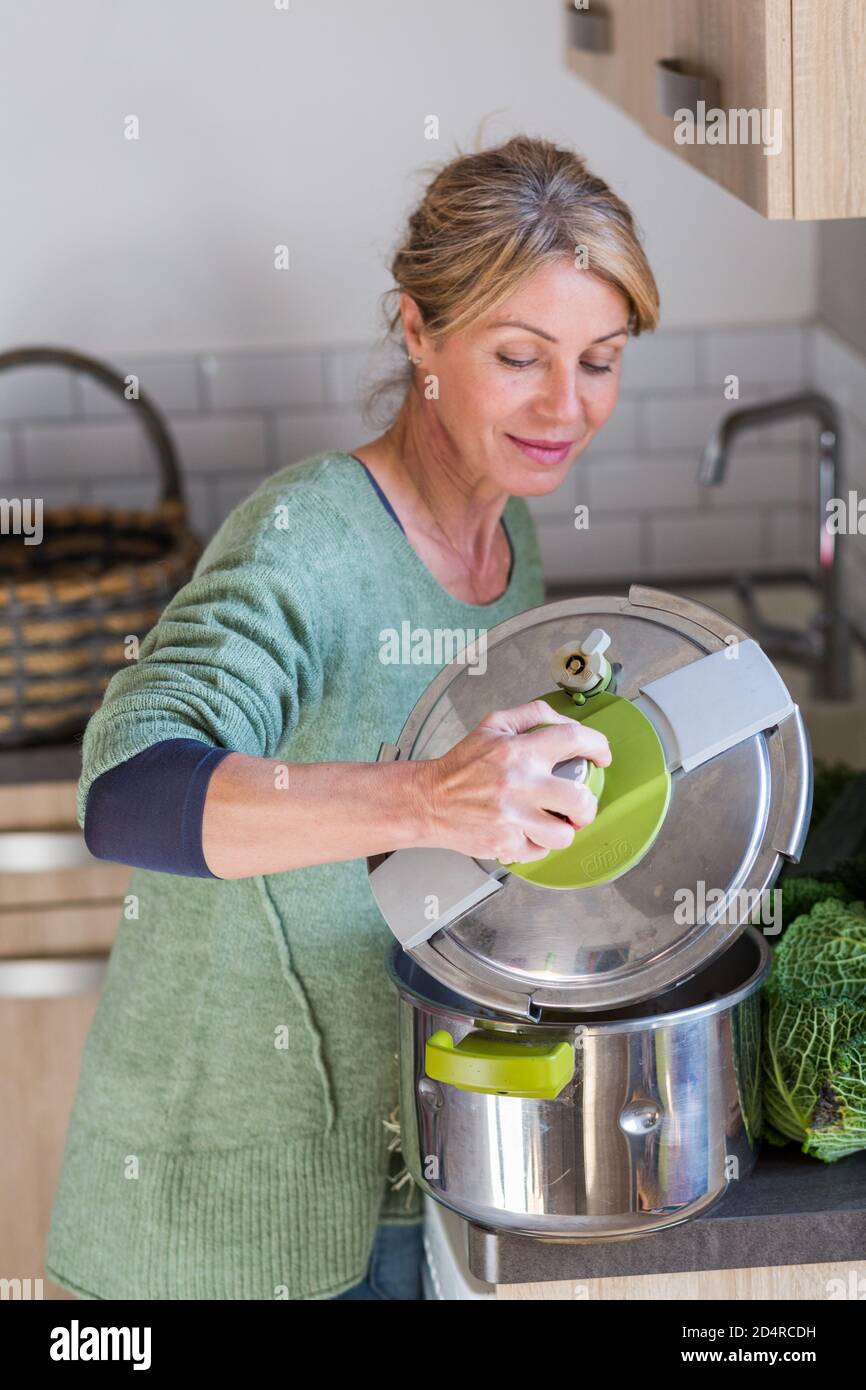 Woman using a pressure cooker Stock Photo Alamy