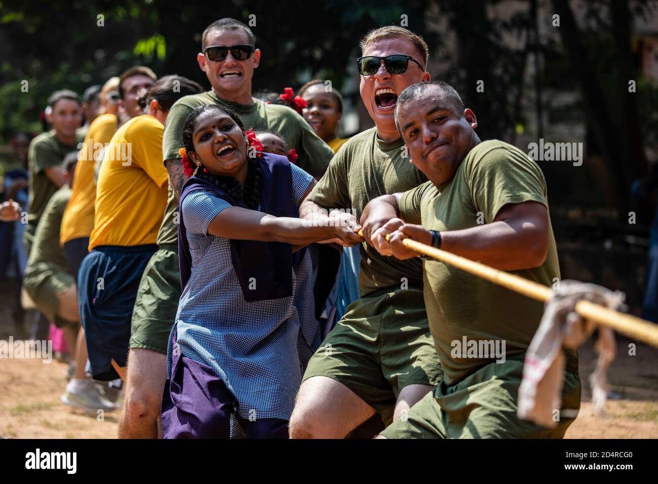 U.S. Marines and Sailors play Tug-of-War with children with the Visakhapatnam Government Home for Girls as part of exercise Tiger TRIUMPH in Visakhapatnam, India on Nov. 15, 2019. Marines and Sailors spent the day playing various children’s games and dances during a community relations project. Tiger TRIUMPH removes cultural and geographical barriers and paves the way for further partnership. (U.S. Marine Corps photo by Lance Cpl. Armando Elizalde) Stock Photo