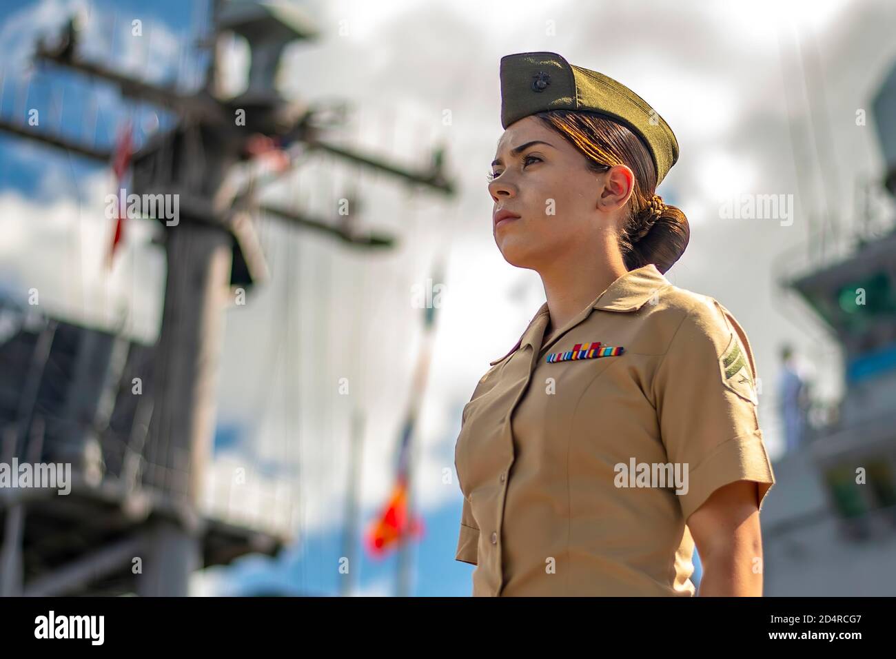 PEARL HARBOR (Nov. 13, 2019) U.S. Marine Corps Cpl. Angela Chang, assigned to 11th Marine Expeditionary Unit (MEU), mans the rails aboard the amphibious assault ship USS Boxer (LHD 4) before a scheduled port visit to Pearl Harbor, Hawaii. The Boxer Amphibious Ready Group (ARG) and 11th Marine Expeditionary Unit (MEU) are deployed to the U.S. 7th Fleet area of operations to support regional stability, reassure partners and allies, and maintain a presence to respond to any crisis ranging from humanitarian assistance to contingency operations. Stock Photo
