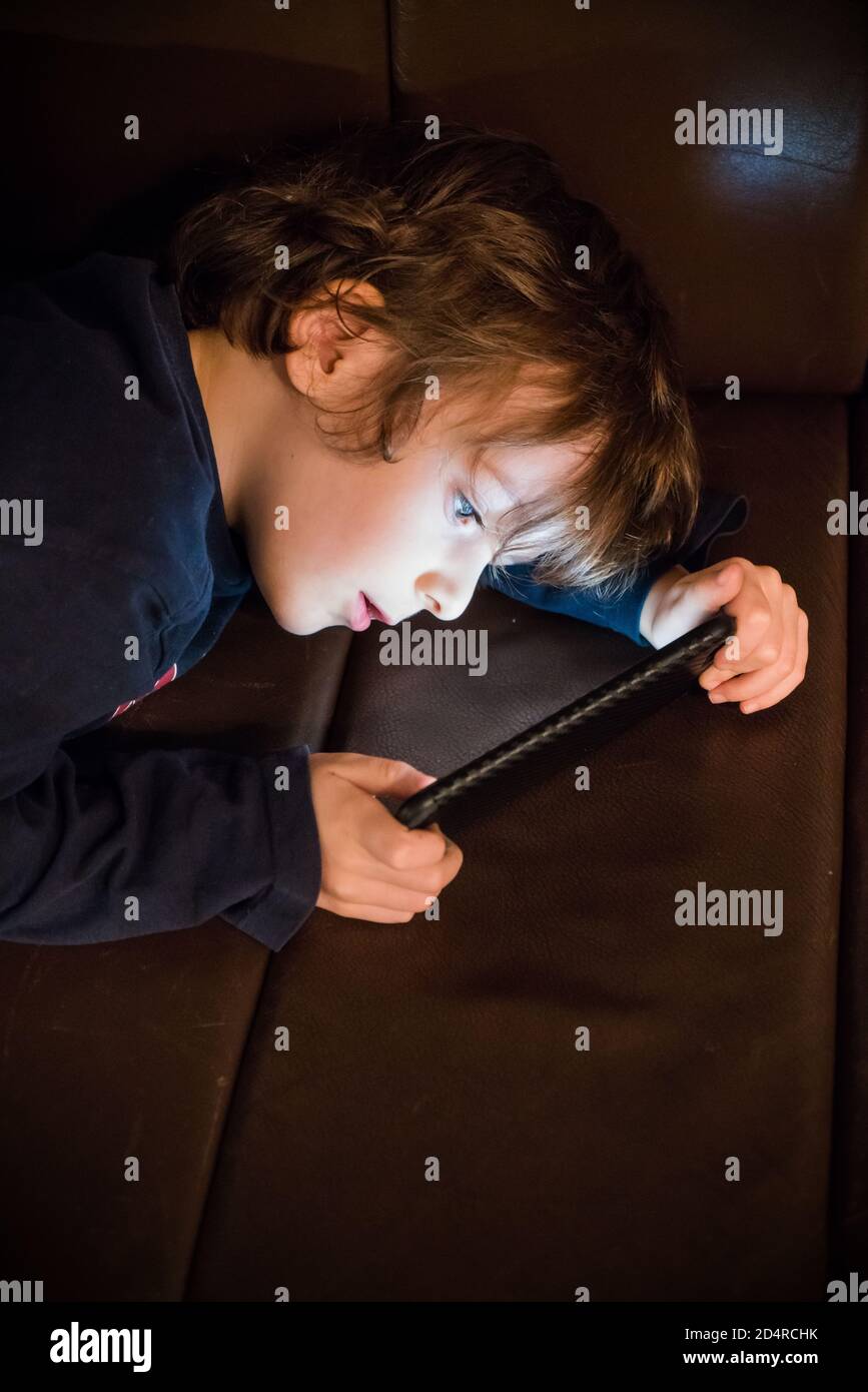 4 year old boy playing with a smartphone. Stock Photo