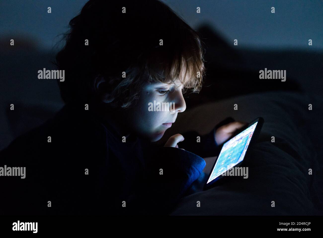 4 year old boy playing with a smartphone. Stock Photo