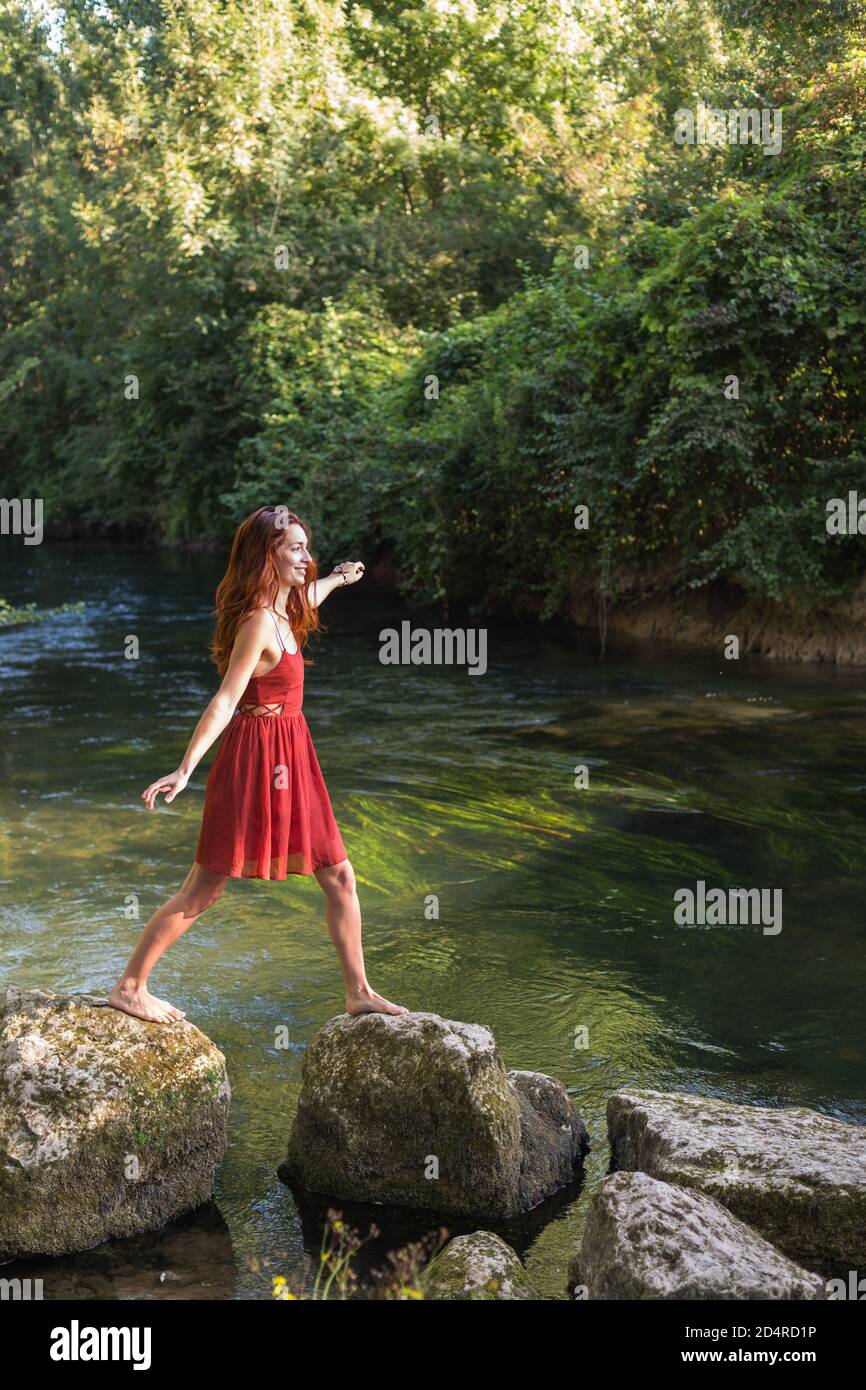 Woman walking on rocks. Stock Photo