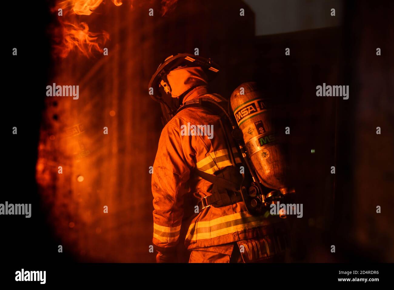 U.S. Senior Airman Jose Villalobos, 31st Civil Engineer Squadron fire protection journeyman, participates in a live fire training exercise at Aviano Air Base, Italy, Oct. 29, 2019. Live fire training is conducted in a burn building, which is a structure built to be intentionally burned for firefighter training. (U.S. Air Force photo by Airman Thomas S. Keisler IV) Stock Photo