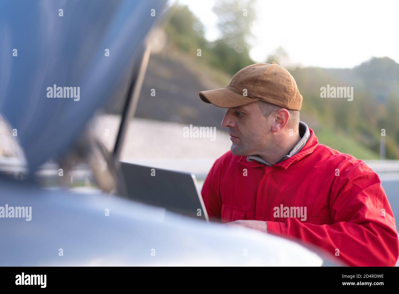 Handsome Auto Mechanic Or Road Assistance Worker In Uniform Repairing 