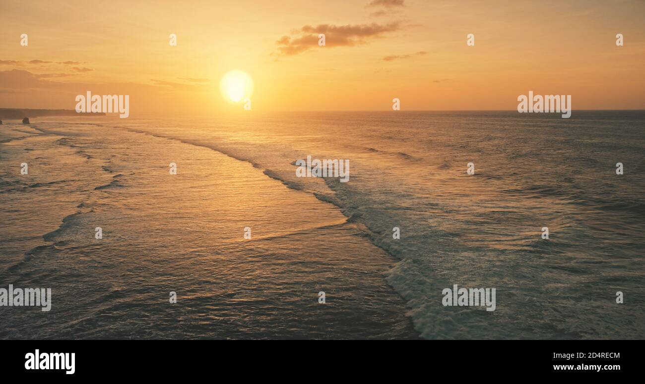 Ocean waves at sun set light aerial view. Sunset wavy seascape at tropical paradise resort of Sumba Island, Indonesia, Asia. Cinematic nobody nature scenery at soft sunlight drone shot Stock Photo