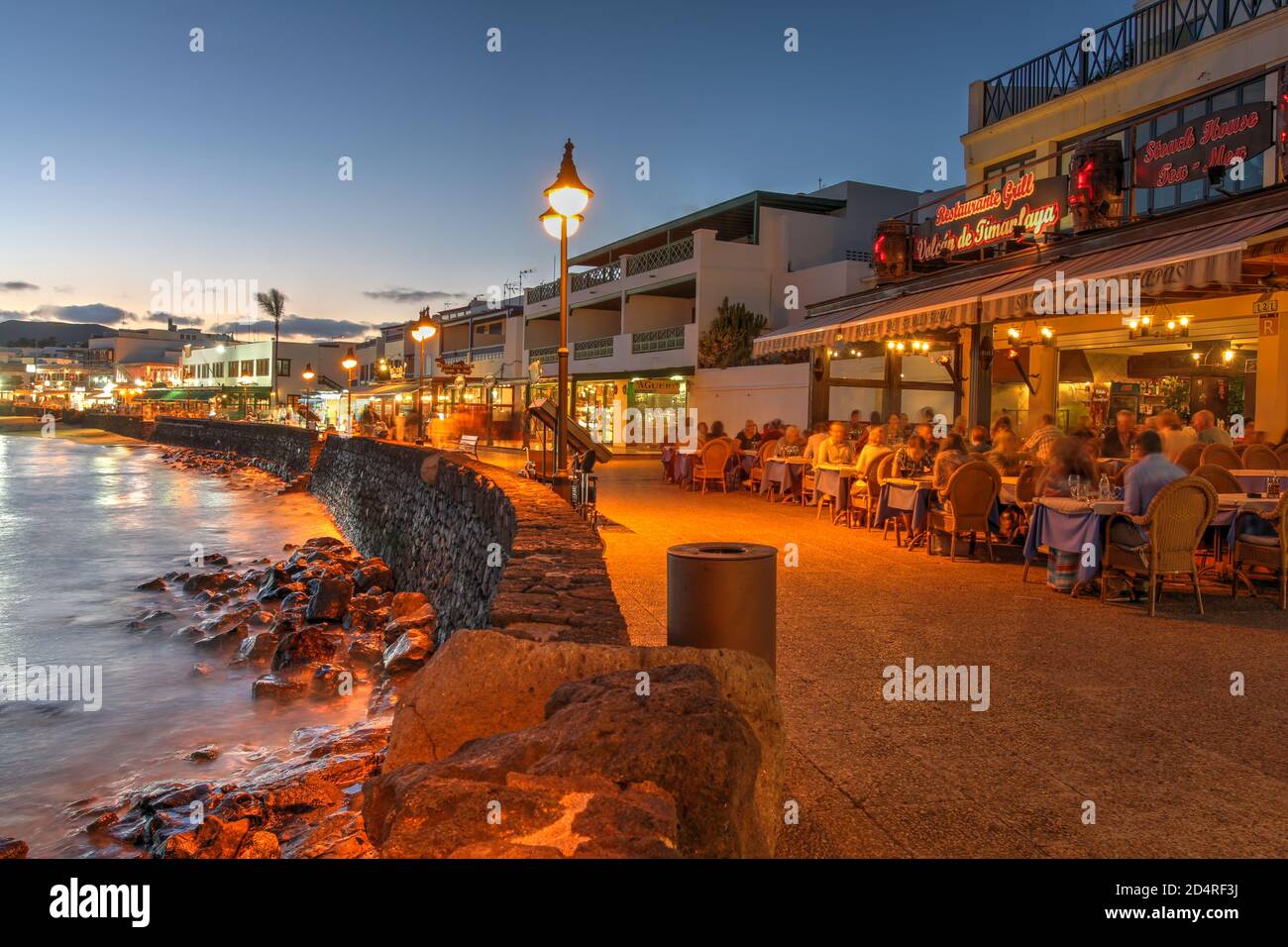 Lanzarote, Spain - April 23, 2014 - Sunset scene by the waterfront of Playa Blanca resort, on Lanzarote, Canary Islands, Spain. Stock Photo