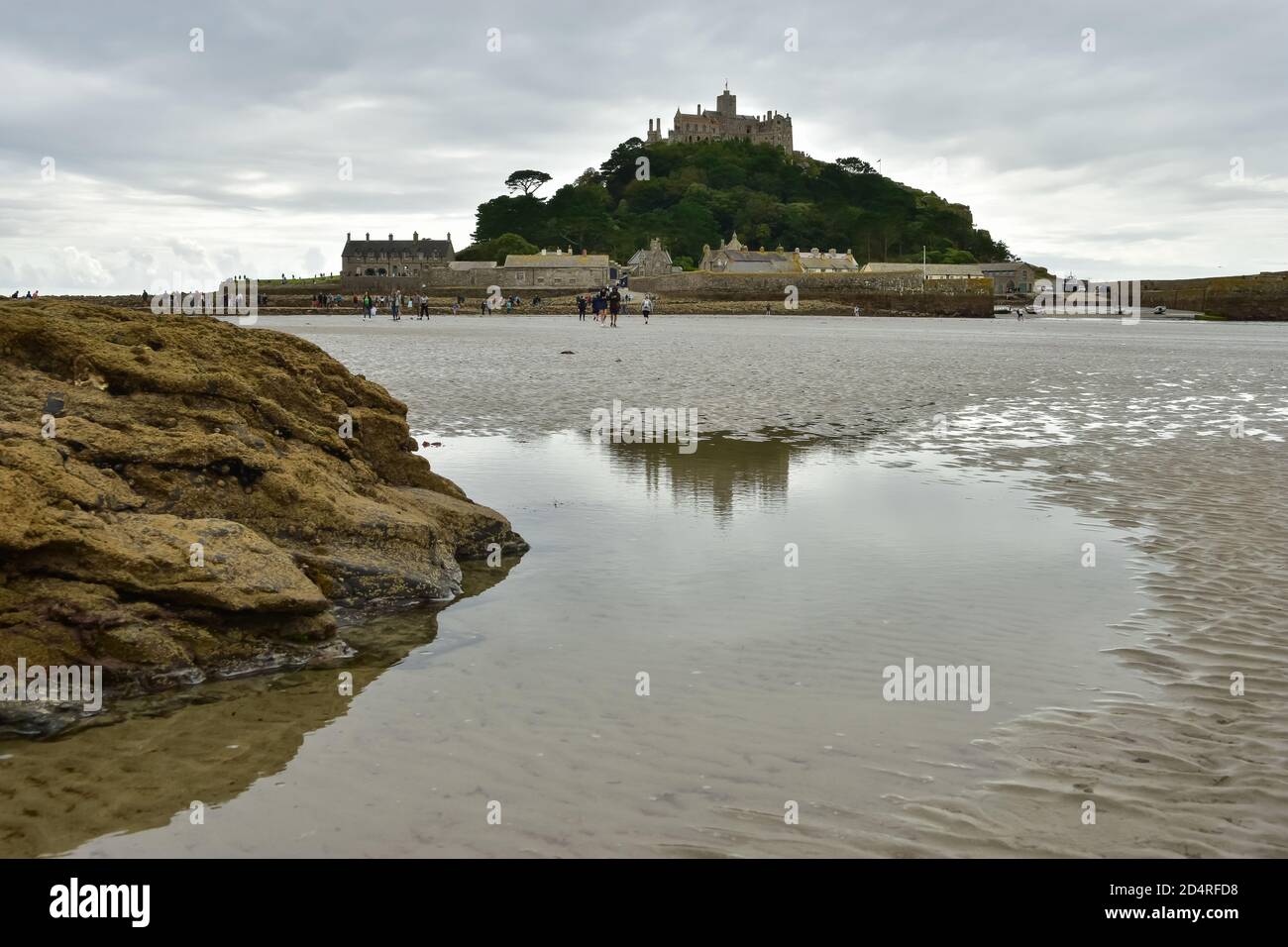 St Michael's Mount in Cornwall connecting to Marazion with a causeway which submerges under the water at high tide Stock Photo