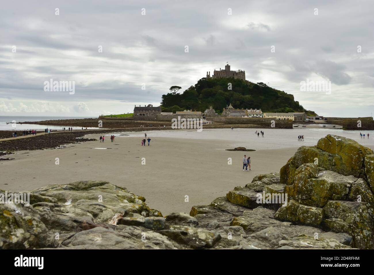 St Michael's Mount in Cornwall connecting to Marazion with a causeway which submerges under the water at high tide Stock Photo