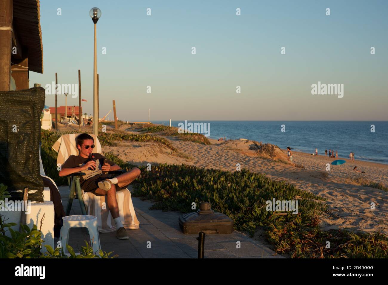 Young man relaxing on Praia de Faro, Portugal Stock Photo