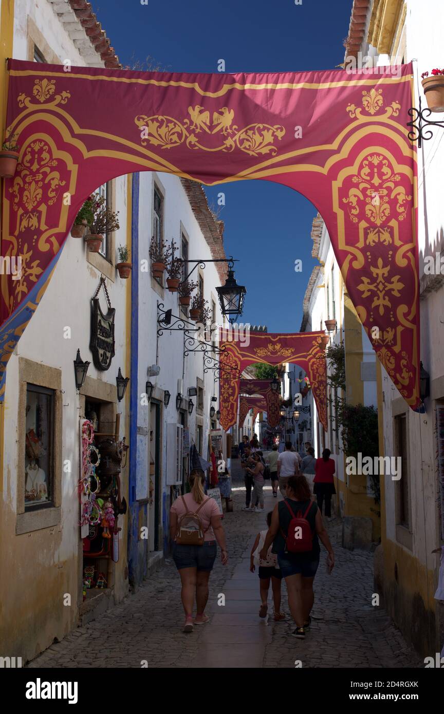 Tourists explore the narrow streets of Obidos, Portugal Stock Photo