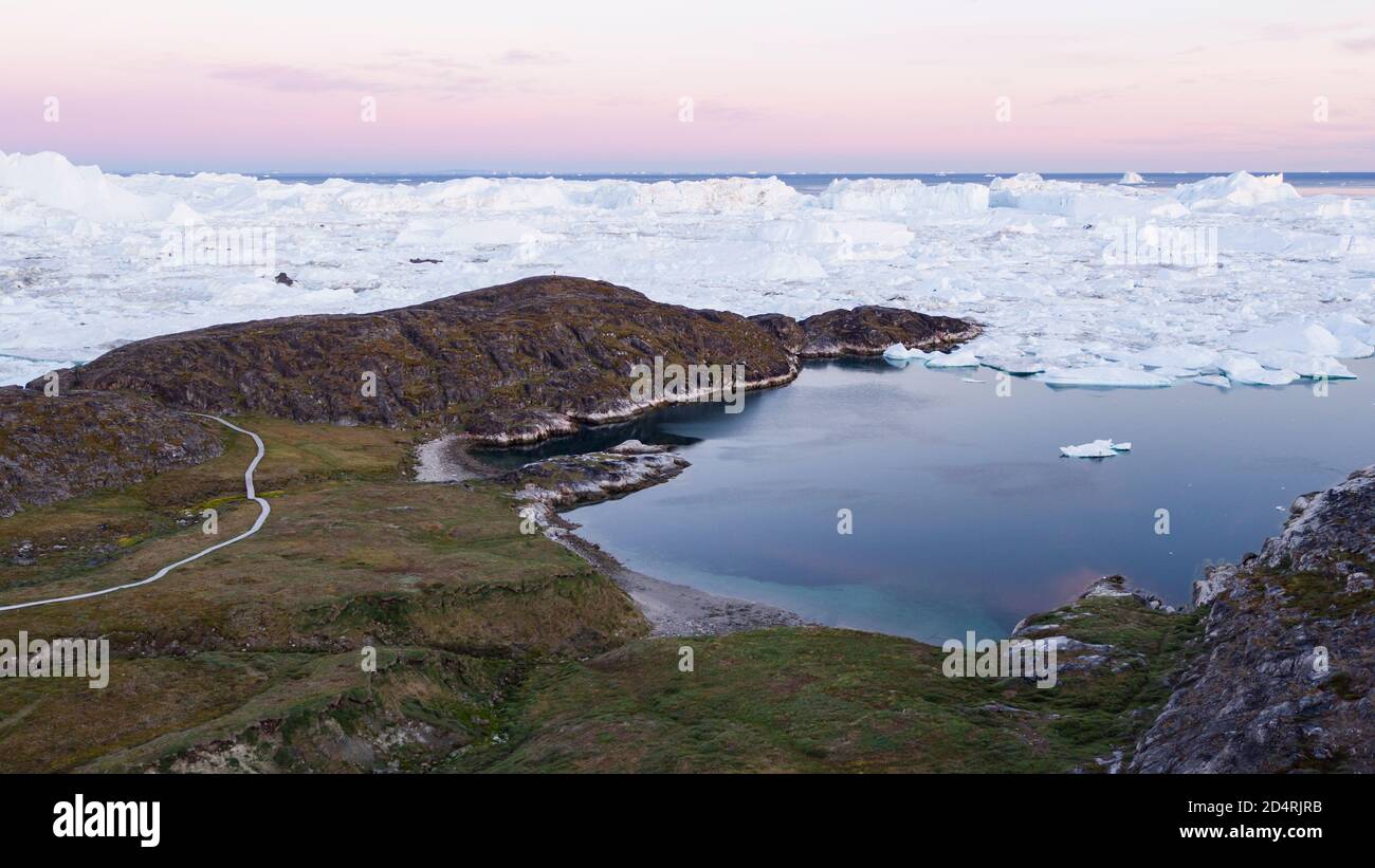 Arctic landscape nature with icebergs and ice in Greenland icefjord. Aerial drone image of ice and iceberg. Ilulissat Icefjord with icebergs from Stock Photo