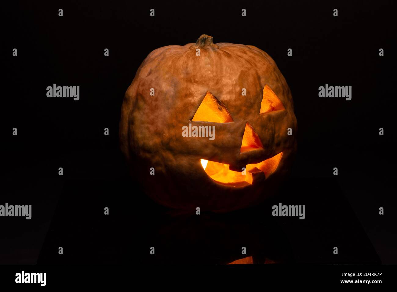 Jack o Lantern isolated on a black background with light inside Stock ...