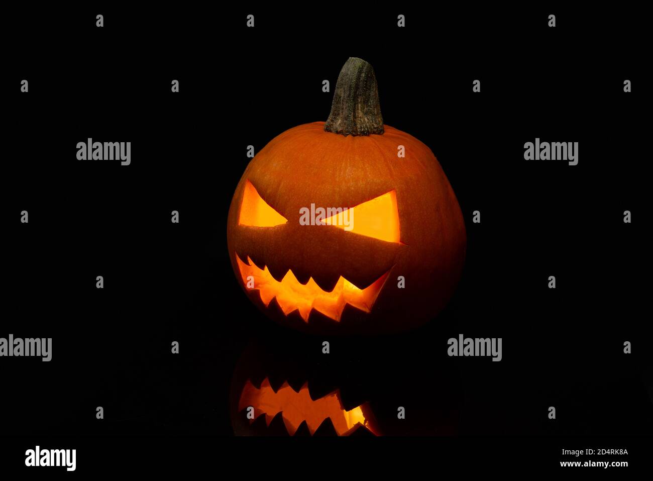Jack o Lantern isolated on a black background with light inside Stock ...
