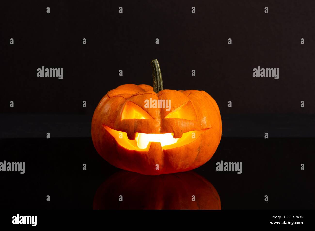 Jack o Lantern isolated on a black background with light inside Stock ...