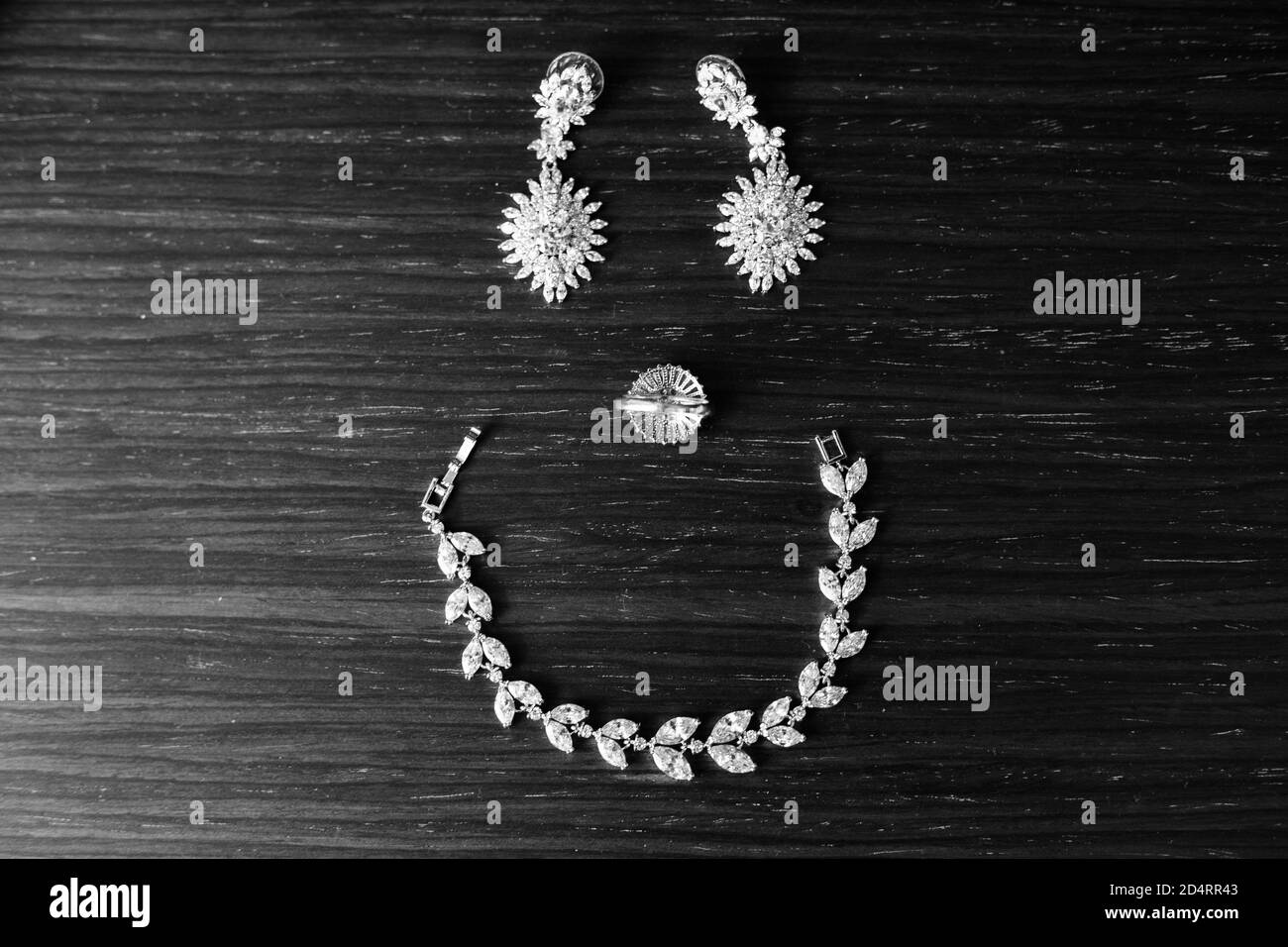 Top view of jewelry forming a smiley face on a black surface Stock Photo