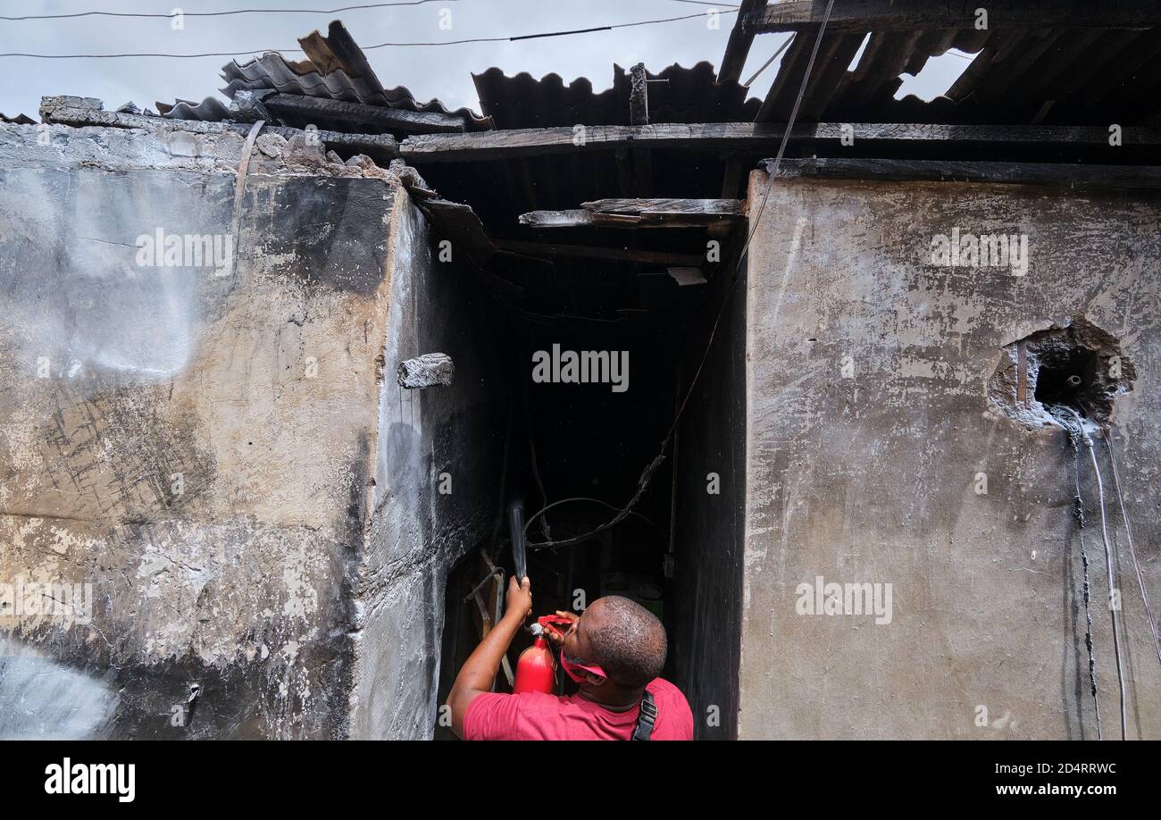 A victim of a fire accident uses a fireextinguisher after a gasladen