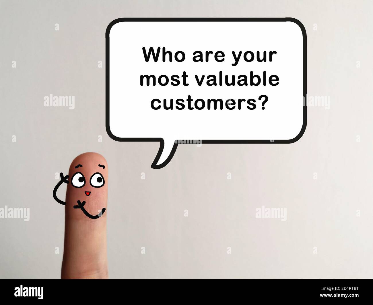 One finger is decorated as a person. The person is asking question about business. He wants to know who is your most valuable customers. Stock Photo