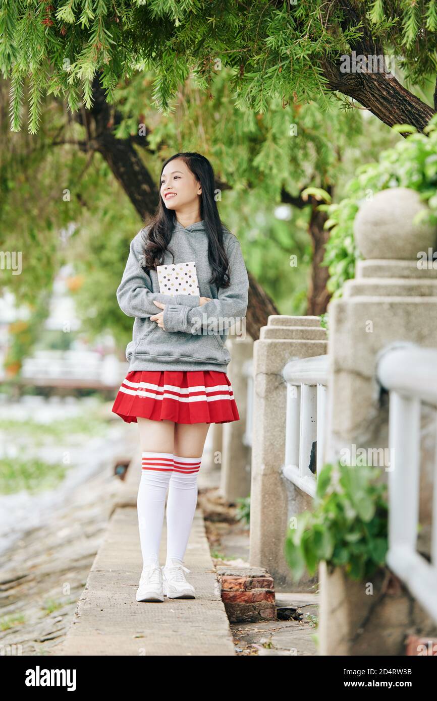 Girl holding book Stock Photo - Alamy
