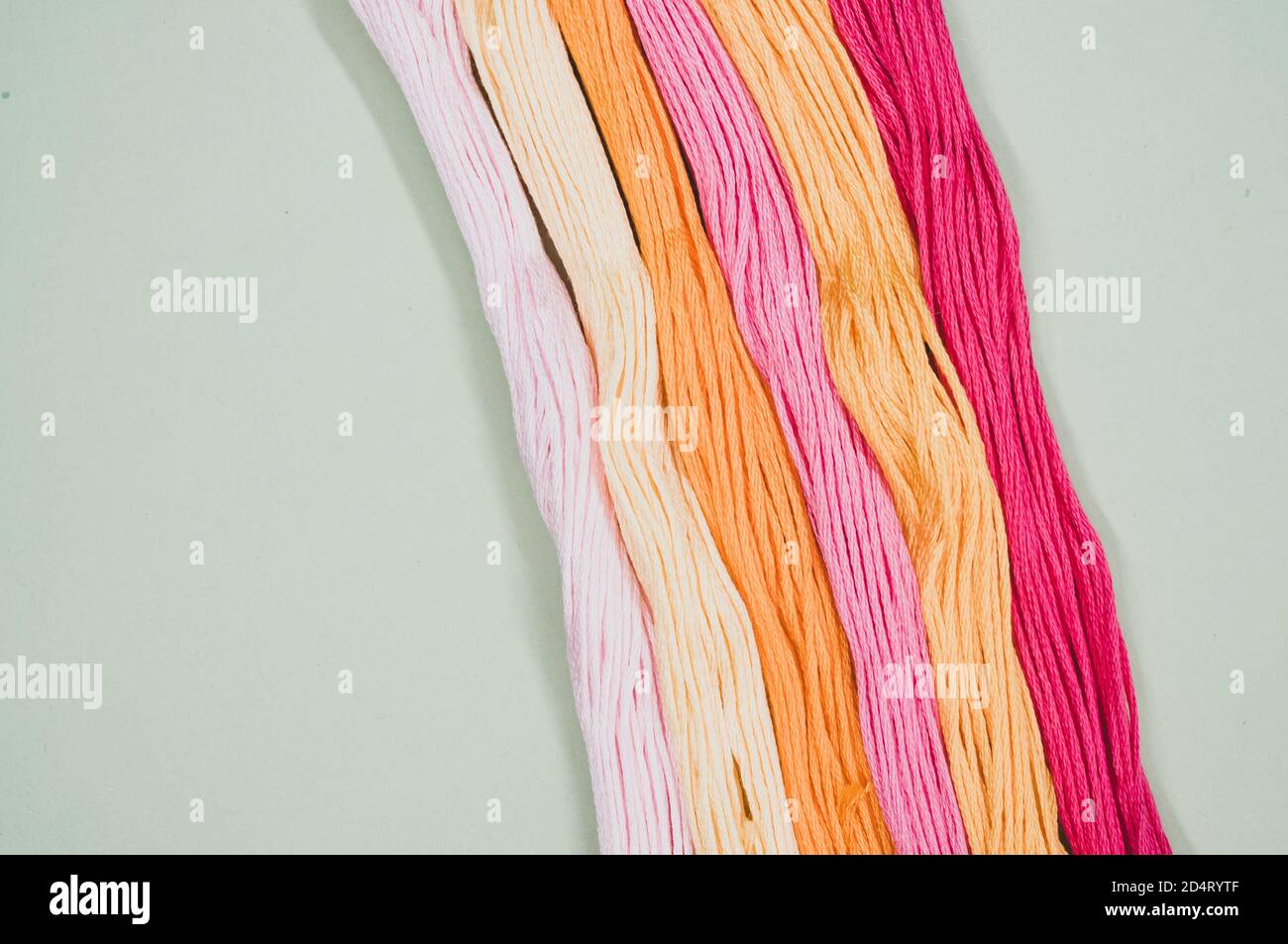 Top view of colorful mouline threads isolated on a mint green ...
