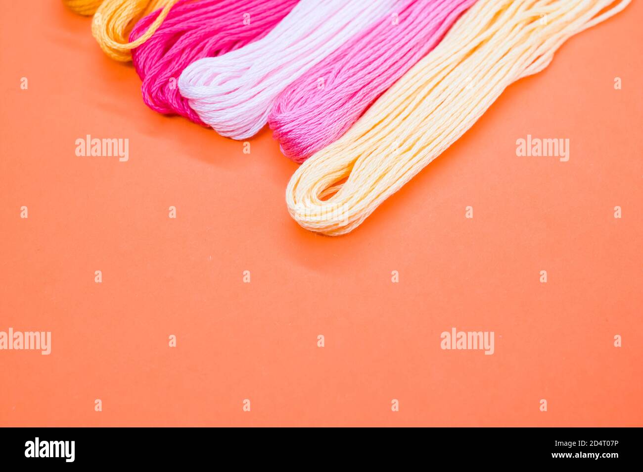 High angle shot of colorful mouline threads isolated on an orange ...