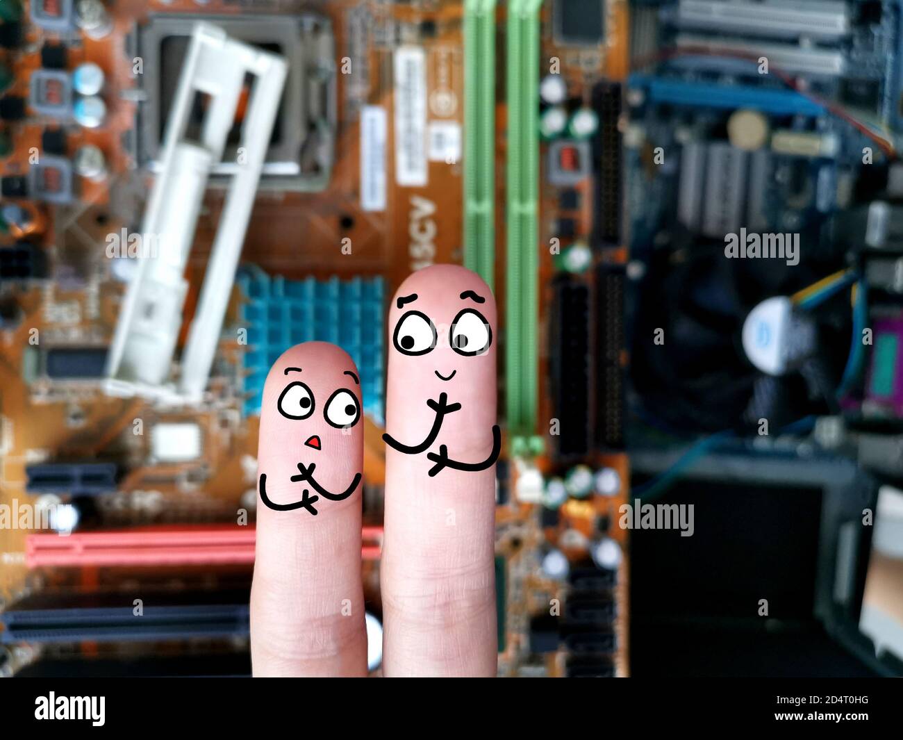 Two fingers are decorated as two person. They are working in information technology field. Stock Photo