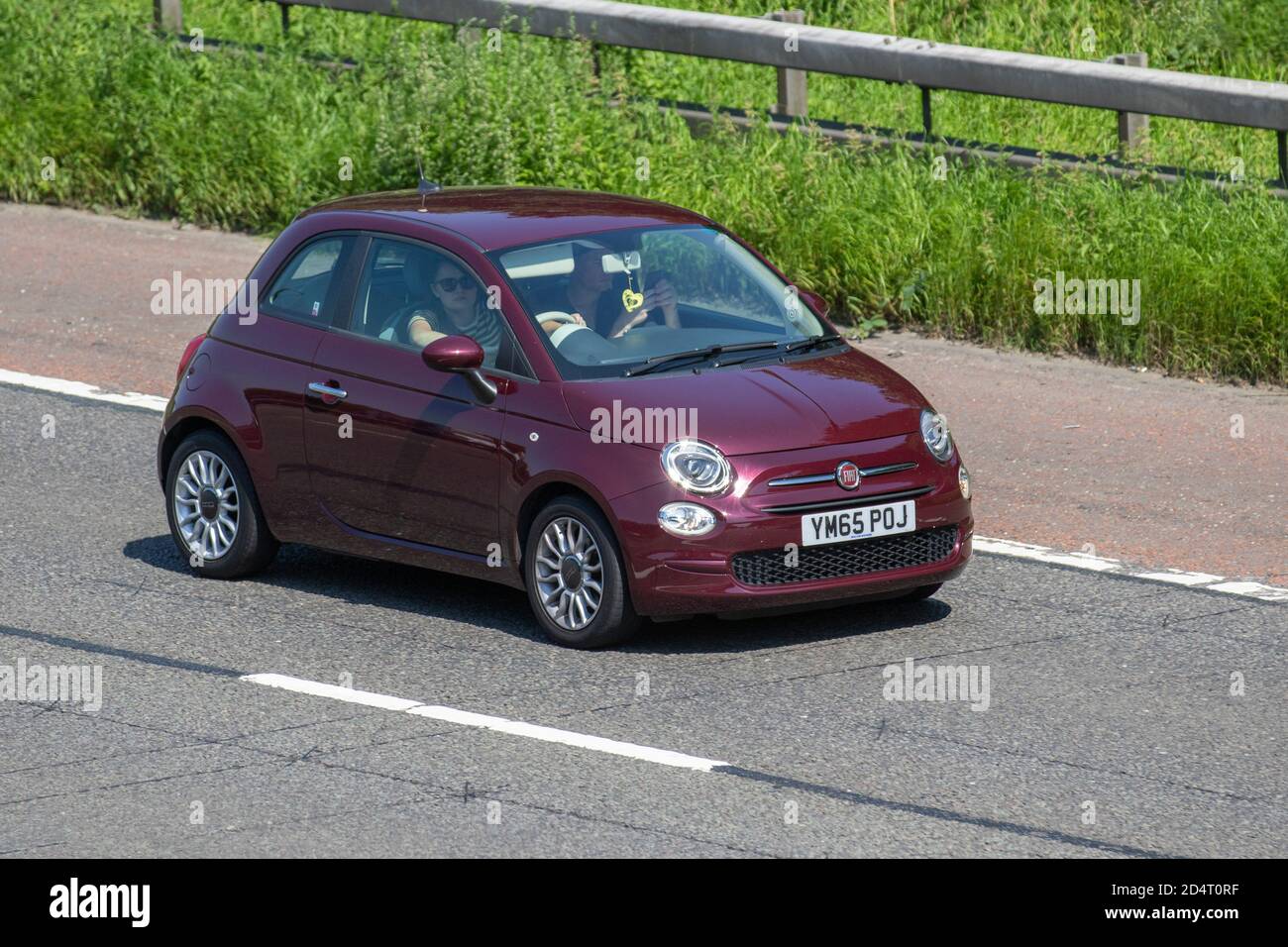 2016 red Fiat 500 POP Star; Vehicular traffic, moving vehicles, cars, vehicle driving on UK roads, motors, motoring on the M6 motorway highway UK road network. Stock Photo