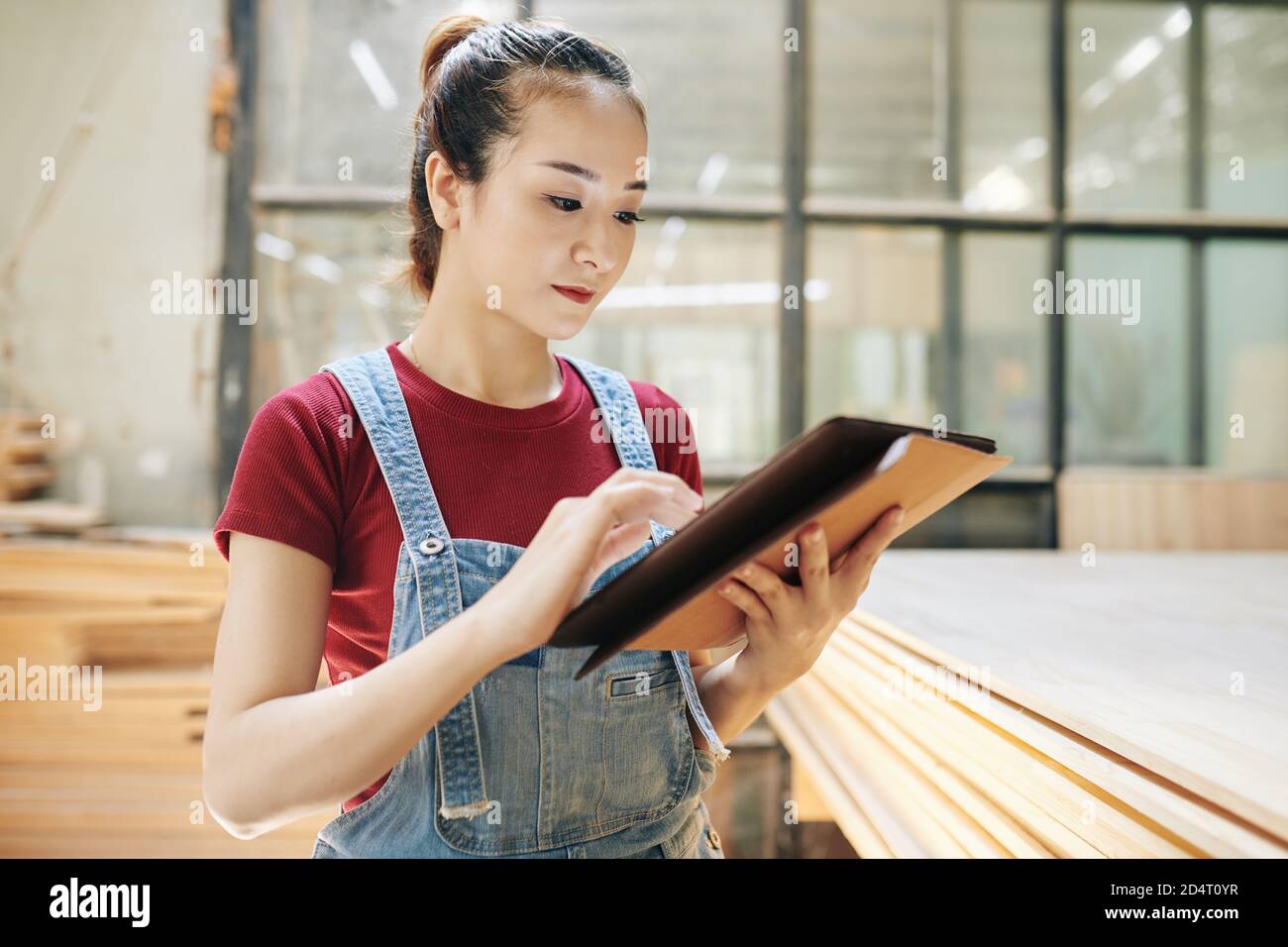 Carpentry shop manager checking e-mails Stock Photo