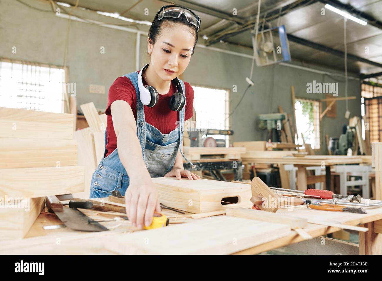 Carpenter measuring crate Stock Photo