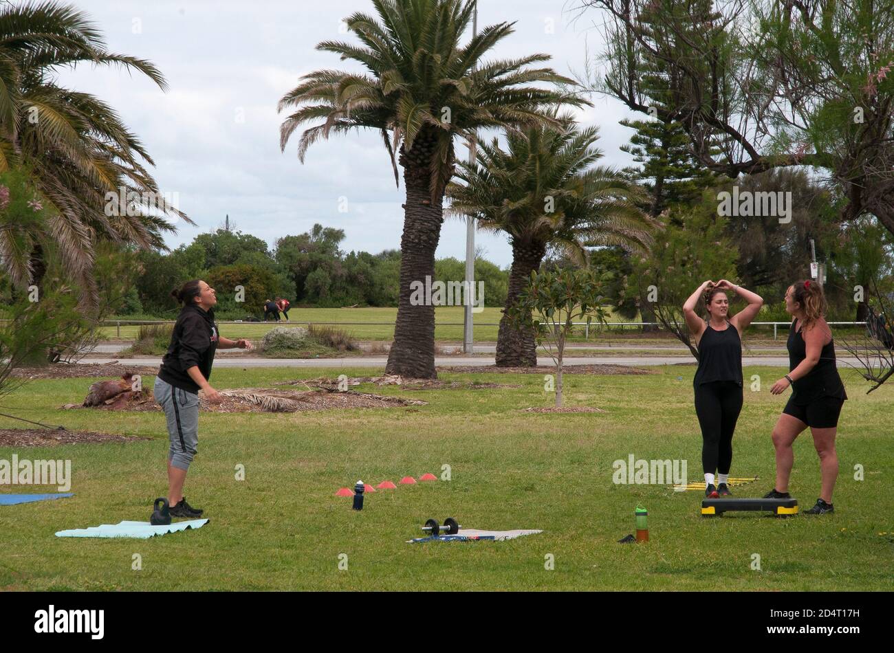 People exercising in a public park during the 2020 pandemic lockdown, Melbourne, Australia, whilst indoor gyms and classes remain closed. Stock Photo