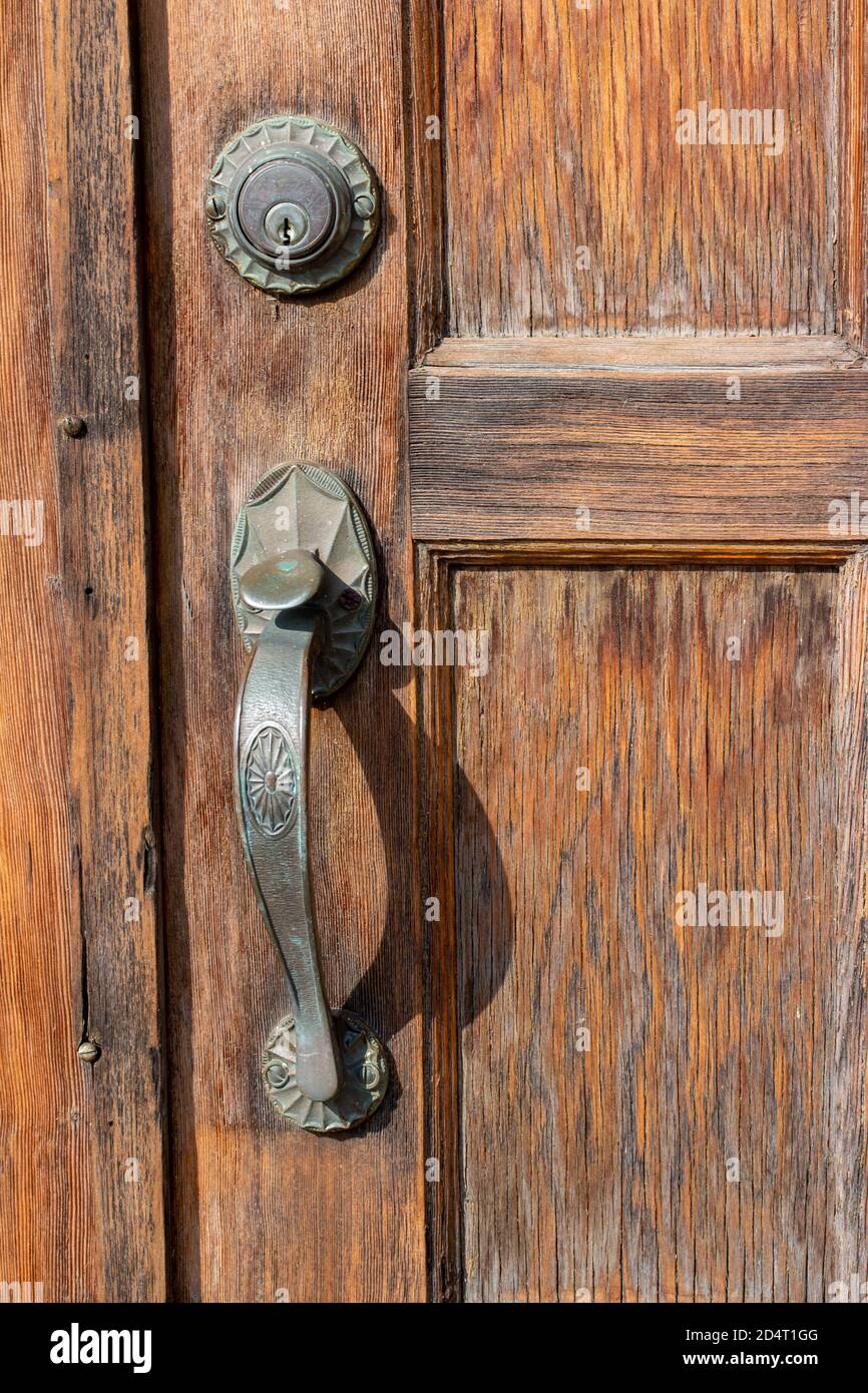 Close up view of an old west style door handle on a weathered vintage  wooden door in bright sunlight Stock Photo - Alamy