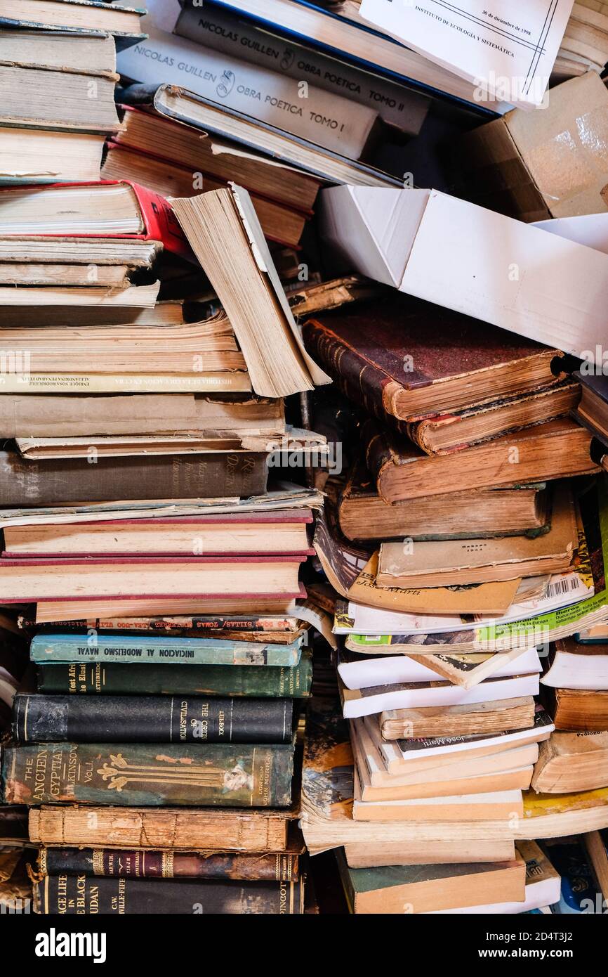 Old vintage pile of books being sold on a Cuban garage sale outside Stock Photo