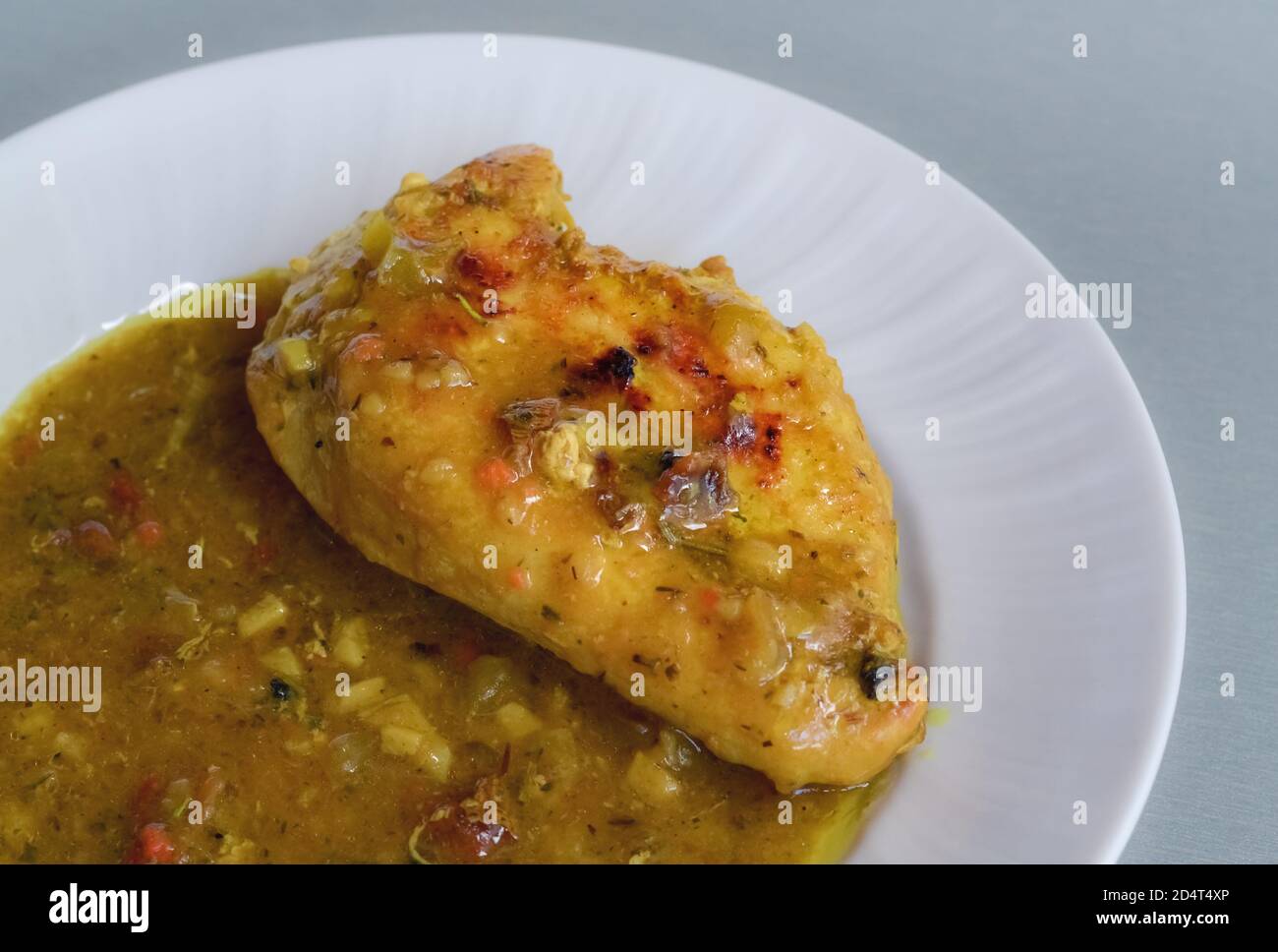 Detail of a dish of chicken meat in tasty curry sauce Stock Photo