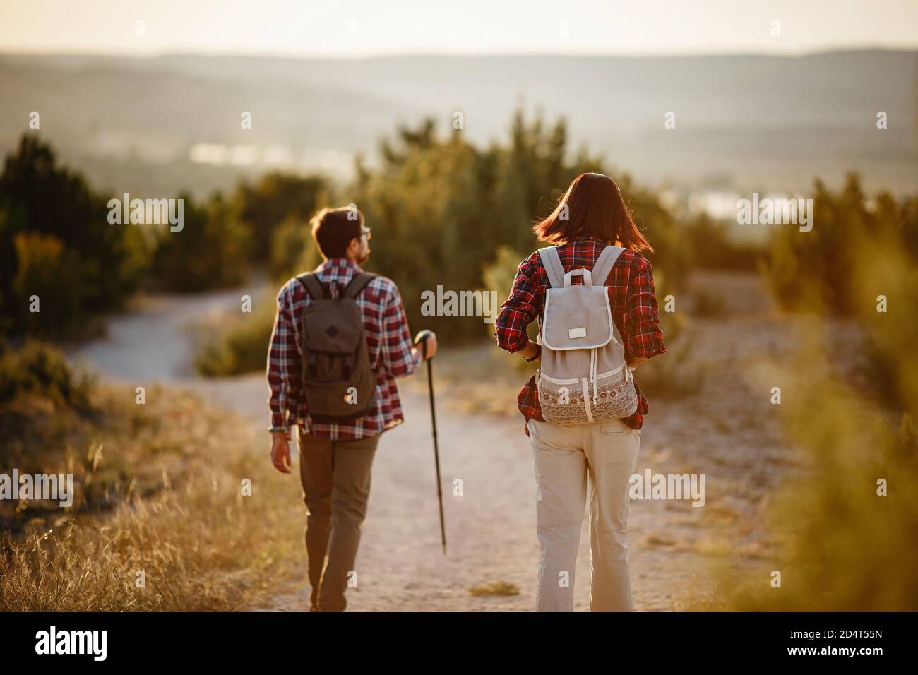 Portrait of happy young couple having fun on their hiking trip ...