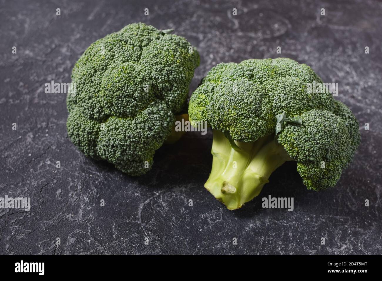Fresh broccoli on dark stone table background Stock Photo