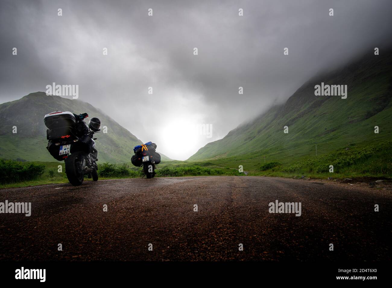 two motor bikes on road trip on small scottish road on foggy and misty