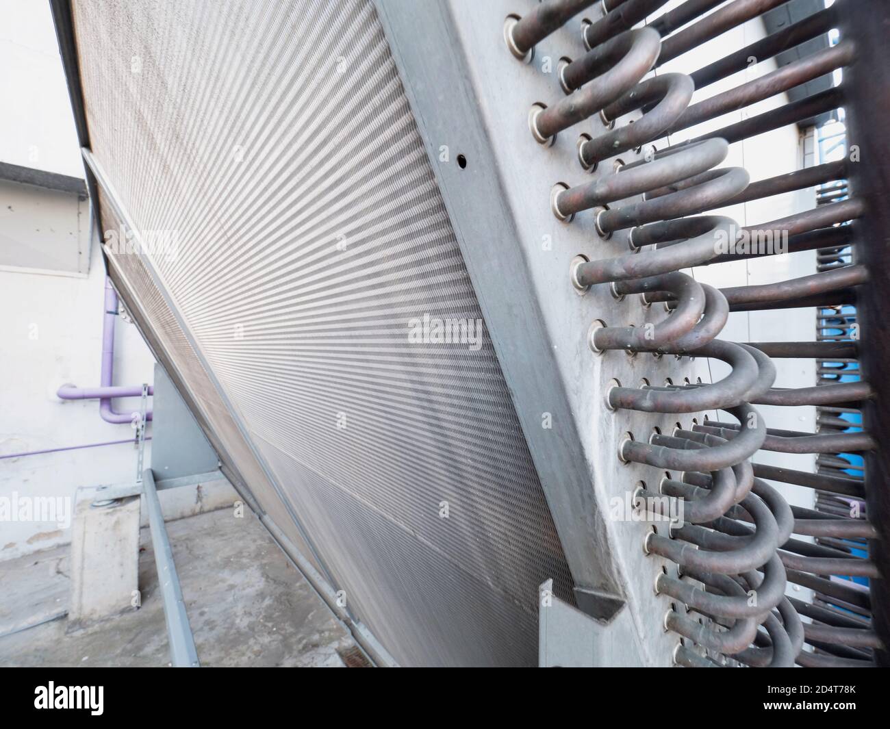 Bent brass pipes of water air cooling industrial unit. The heat