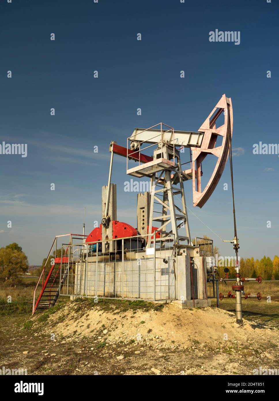 Oil rigsrocking on the oil field near the road. Oil rig. Oil industry