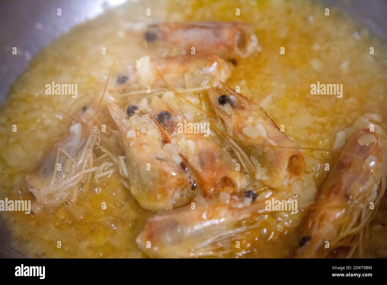 Prawn Heads and Onions Simmering in Pan for Stock Stock Photo